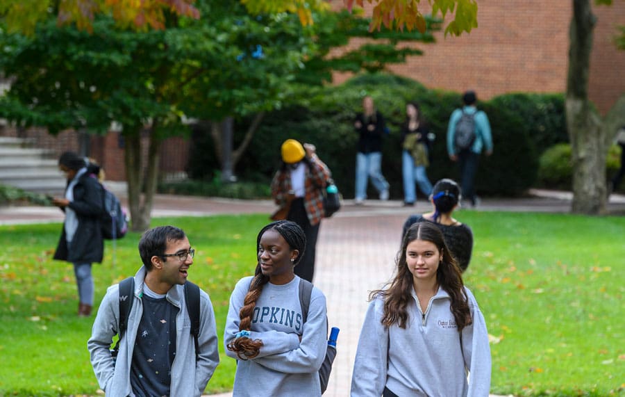 students walking outdoors on campus