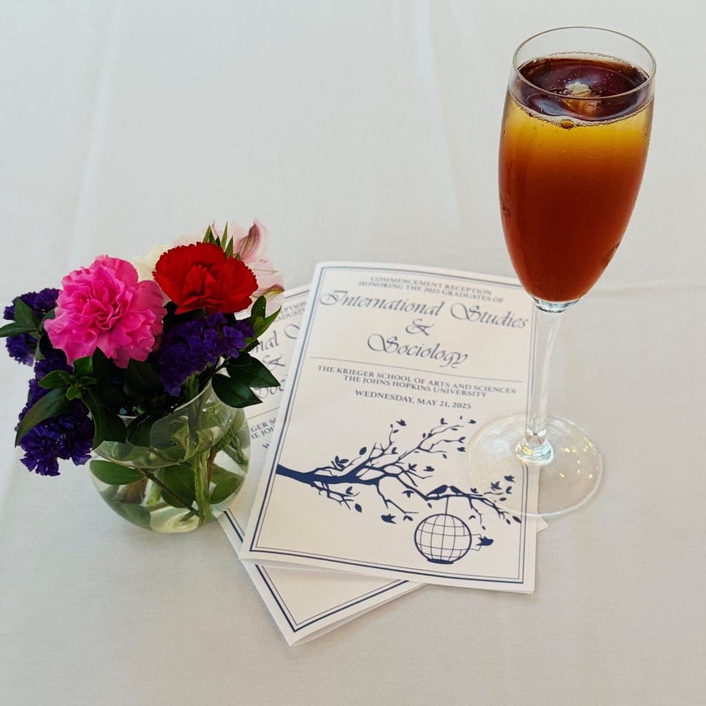Commencement program, flowers, glass of champagne